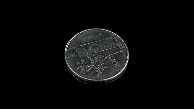 Italian 100 lire coin from 1977 representing goddess Minerva facing left reaching an olive tree