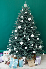 New Year's holiday Christmas tree decor with gifts and interior garlands