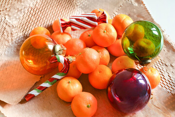 Christmas decorations and tangerines on wrapping paper background