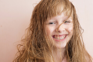 a blonde girl with very matted hair laughs
