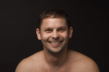 Obraz premium Handsome man on the black background. Muscular and athletic. Man portrait. Male model in studio. 