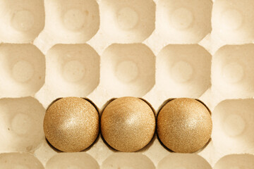 Top view easter composition with golden eggs, creative spring holiday flat lay with painted chicken egg.