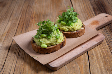 Avocado toast on wooden board.