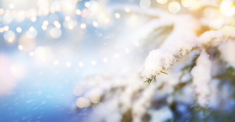 An abstract festive winter Christmas background with blurred light bokeh against the snow.