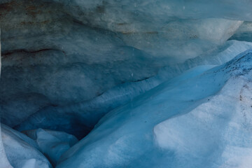 Glacier close up. Blue ice in mountains. Ice cold texture