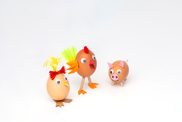 simple figurine for kids made of eggshell and paper, isolated on white, holiday activity with parents, handmade crafting hobby