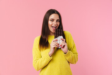 Happy beautiful girl smiling while eating chocolate