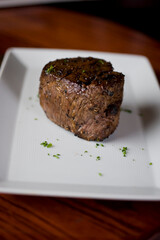 Steak. Grass-fed skirt steak, grilled to a medium rare and served with a garlic herb butter sauce and paired with roasted potatoes and Brussels sprouts. Classic American steakhouse favorite.