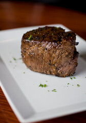 Steak. Grass-fed skirt steak, grilled to a medium rare and served with a garlic herb butter sauce and paired with roasted potatoes and Brussels sprouts. Classic American steakhouse favorite.