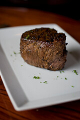 Steak. Grass-fed skirt steak, grilled to a medium rare and served with a garlic herb butter sauce and paired with roasted potatoes and Brussels sprouts. Classic American steakhouse favorite.