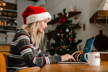 Focused nice girl working with laptop and drinking tea