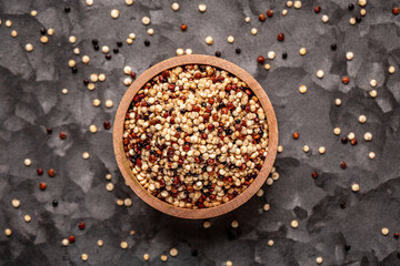 Mixed quinoa red, white and brown quinoa in wooden bowl. Healthy and gluten free food. banner, menu, recipe, place for text. top view