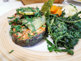 Grilled salmon served with grilled eggplants on top and mixed vegetables for side dishes for an healthy meal