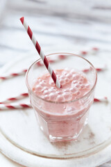 Strawberry Smoothie on bright wooden background. Close up.	