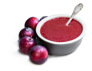 Homemade chutney from plums in clay bowl isolated on white