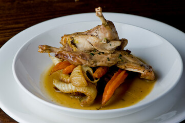 Chicken pan seared in garlic, butter, shallots and white wine. Classic fine dining cuisine. Served with steamed vegetables, broccoli carrots cauliflower, garnished with lemons and Italian parsley.