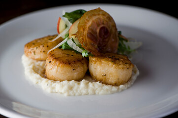 Scallops sautéed in olive oil, topped with crushed almonds, garnished w/ scallions, parsley & served with organic vegetables. Classic Italian, American restaurant or French bistro entree.
