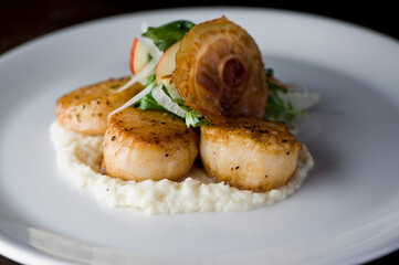 Scallops sautéed in olive oil, topped with crushed almonds, garnished w/ scallions, parsley & served with organic vegetables. Classic Italian, American restaurant or French bistro entree.