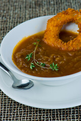 French Onion Soup. Classic traditional french restaurant bistro menu item. French onion soup, yellow onions reduced in broth topped with cheese melted and served with homemade baguettes. 
