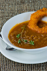 French Onion Soup. Classic traditional french restaurant bistro menu item. French onion soup, yellow onions reduced in broth topped with cheese melted and served with homemade baguettes. 