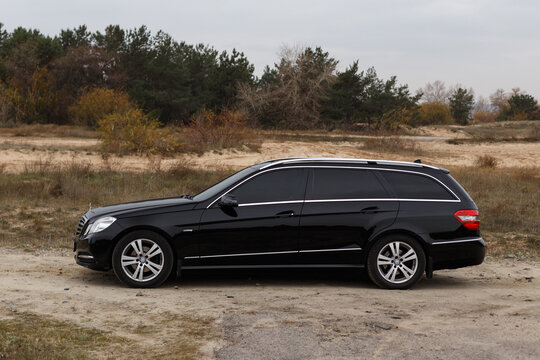 Dnipro, Ukraine - november 21, 2020: Mercedes-Benz E220 CDI 2011 black color in the autumn city near the forest