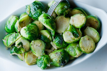 Brussels sprouts shaved and served with crispy bacon and seasoned with olive oil and seasoned with salt and pepper and fresh herbs. Classic American Restaurant appetizer favorite. 