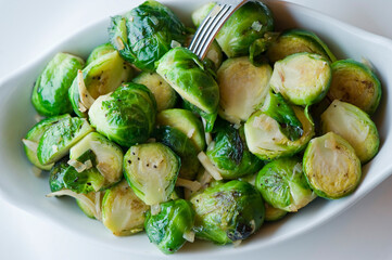Brussels sprouts shaved and served with crispy bacon and seasoned with olive oil and seasoned with salt and pepper and fresh herbs. Classic American Restaurant appetizer favorite. 