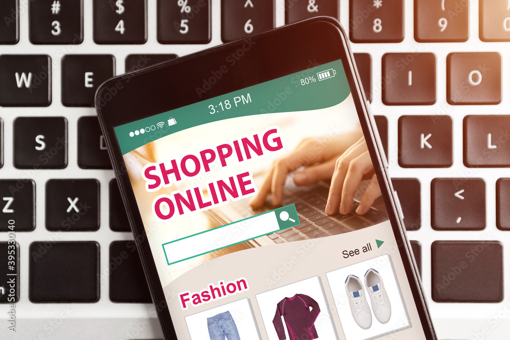 Poster Mobile Phone With Online Shopping App Lying On Computer Keyboard
