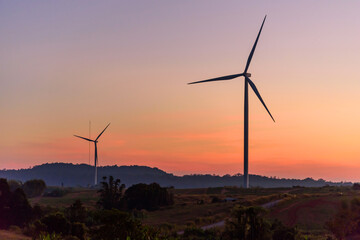 wind turbines park for make the electric power from wind in sunset time