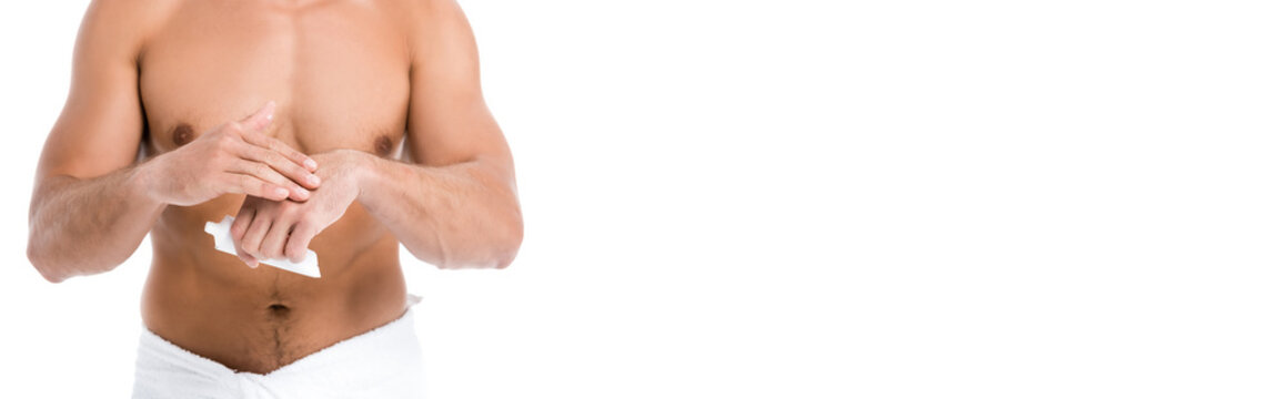 cropped view of shirtless man in towel applying hand cream isolated on white, banner