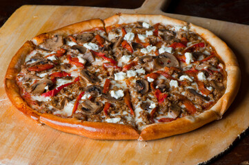 Pizza. Hand rolled pizza dough, topped with homemade tomato sauce seasoned with garlic, basil leaves salt and peppers. Topped with pepperoni and shredded mozzarella cheese then baked to a golden crisp