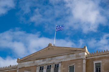 Fototapeta na wymiar Greek flag waving against blue sky background.