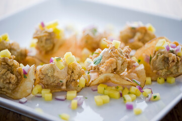 Fried oysters. Fresh oysters fried and served with garlic, shallots, cocktail sauce, mignonette sauce and fresh lemons and limes. Classic American steakhouse or French bistro appetizer.