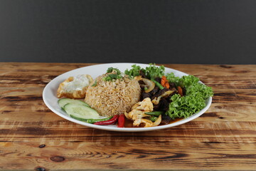 Delicious Meat Fried Rice with salad and cucumber