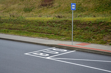 bus stop consisting of a reserved place with the word bus. Horizontal traffic sign white lines. The...