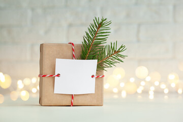 Christmas handmade gift box decorated with evergreen branch and empty blank gift card. New Year concept.