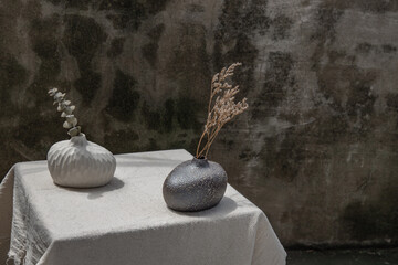 Fototapeta na wymiar Dried flowers in Handmade Double Ceramic Vases on table. Home decor, Space for text.