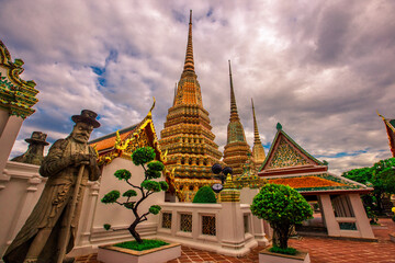 Fototapeta premium background of important religious attractions in Bangkok (Wat Phra Chetuphon (Wat Pho - reclining Buddha), a large pagoda and beautiful sculptural art give future generations to explore its history