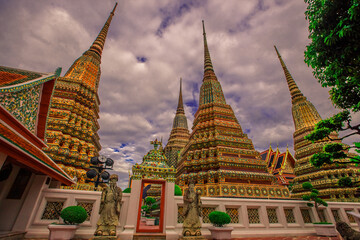Fototapeta premium background of important religious attractions in Bangkok (Wat Phra Chetuphon (Wat Pho - reclining Buddha), a large pagoda and beautiful sculptural art give future generations to explore its history