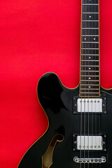 Plakat Detail of Electric Guitar on a red background.