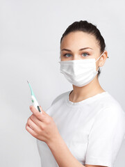 Woman with mask measuring body temperature