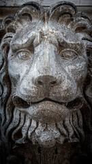 Fototapeta na wymiar Ancient decoration element of scary lion head at roof of Basilica San Marco and Doge Palace in Venice, Italy