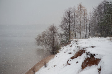 snow-covered river bank and fog