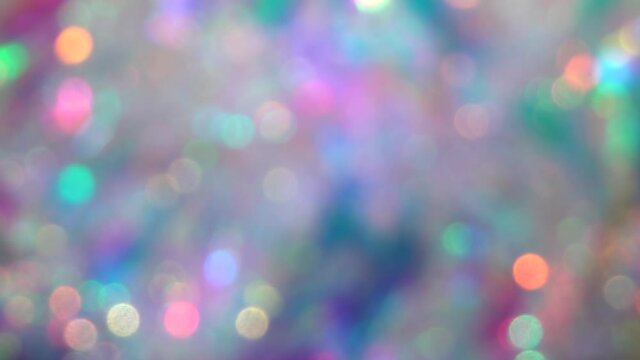 Soft pastel neon pink blue purple silver crystal lights bokeh. Luxury background for Christmas party. Blurred holographic holiday lights. Posterized Abstract Effect