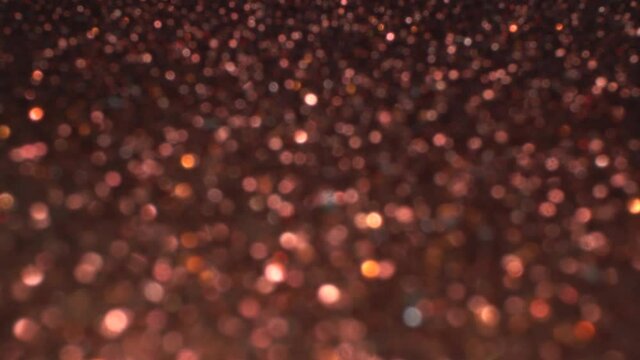 Copper bokeh holiday background for Christmas new year party. Magic shiny metallic texture, glitter and lights