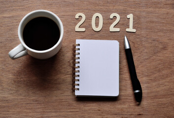 New Year 2021 concept with background of cup of coffee and note pad