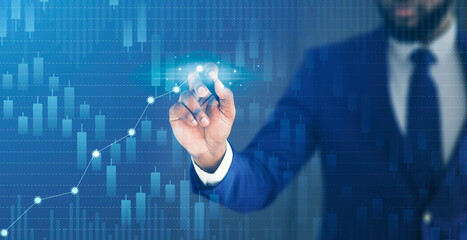 Business growth and economical progress concept. Businessman drawing raising virtual financial chart