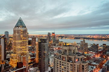 Buildings, Skyscrapers and Towers in Manhattan at Evening Time on a Cloudy Day of Winter. Hudson River and Jersey City in Background. New York City, USA