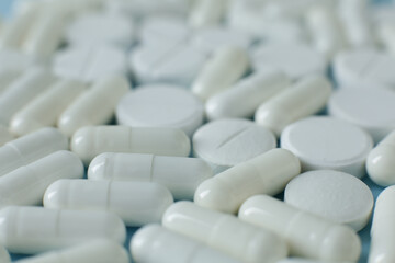 White pills on blue background