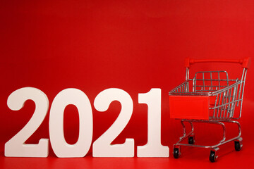 2021 Shopping Cart on Red background - new year 2021 - Business Shopping stores to buy goods...